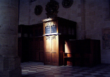 Image of penitent in a confessional booth, one option for the reception of the Sacrament of forgiveness
