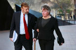 Image of Maureen O'Connor with her attorney. Her attorney says a tumor may have made her gamble and lose a billion dollars over the past nine years. 
