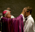 Image of Pictured. A Bishop placing ashes on the head of a penitent on Ash Wednesday 