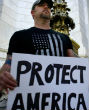 Image of Protesters stand in snow (not pictured) to stand against new influx of refugees into America (AP).