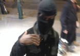 Image of Masked man revealed an ISIS flag and beheading video on his phone (InfoWars).