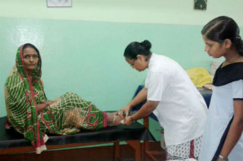 Sr. Philomena Guria RNDM treating a snake bite patient